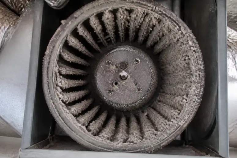 Turbine de ventilation encrassée par la poussière à l'intérieur du caisson de VMC